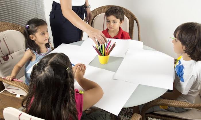 Group of children sitting around a table