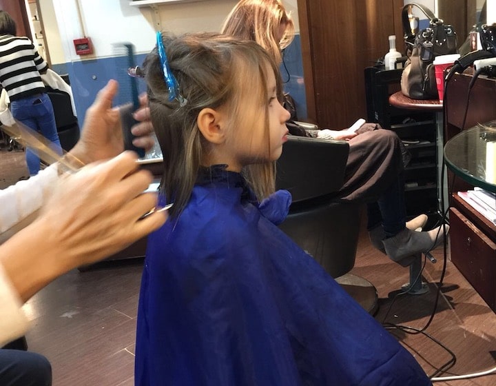 Little girl getting her hair cut Tommy Hair Design