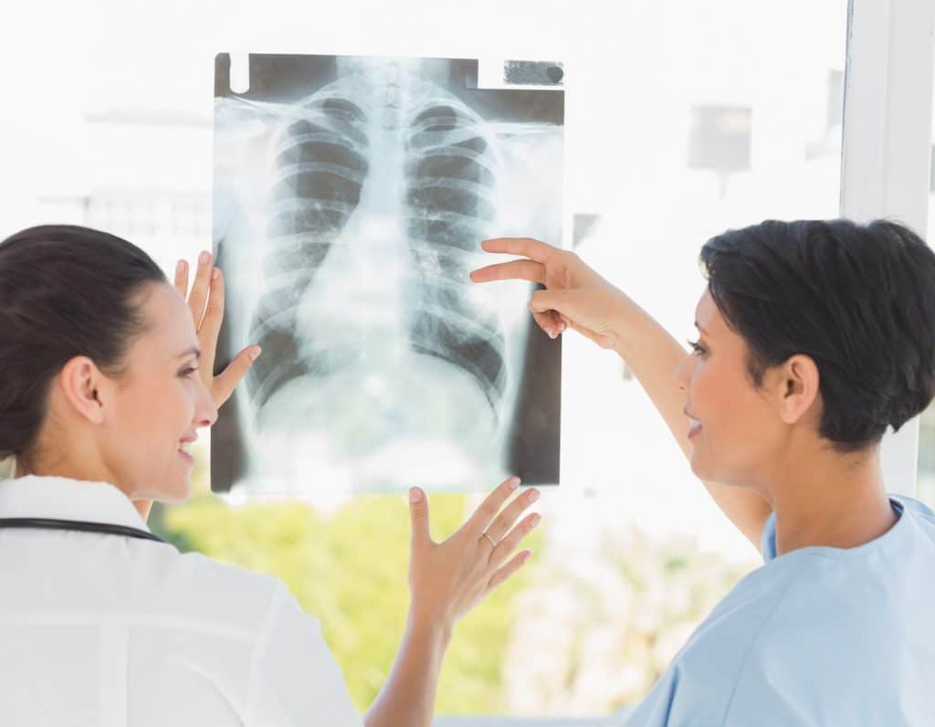 Doctor checking xray with patient bone density