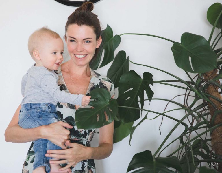 Gemma Blest holding son with plant