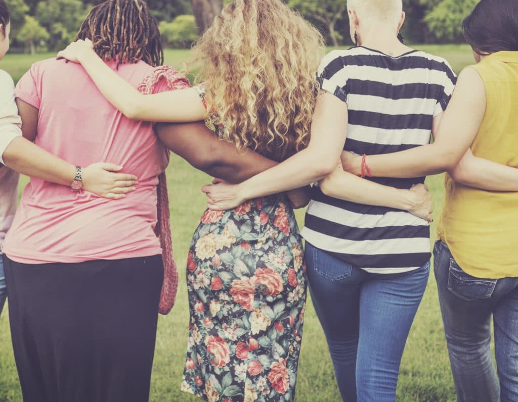 Women holding arms