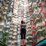 Traveler Exploring Densely Populated Housing Apartments in Hong Kong
