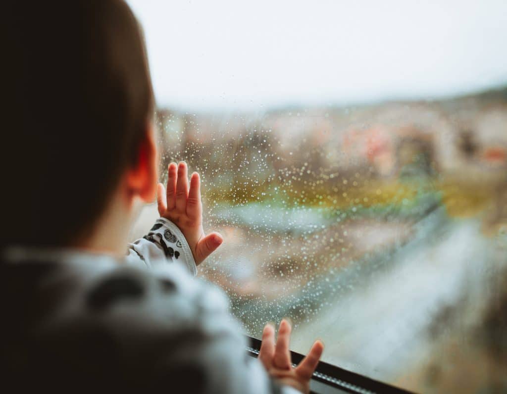 Indoor activities boy in rainy window