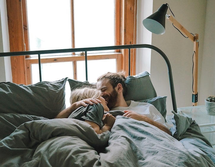 man-woman-snuggle-in-bed