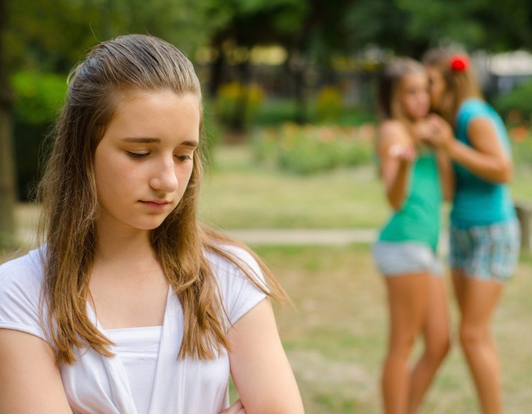 Girl alone friends laughing