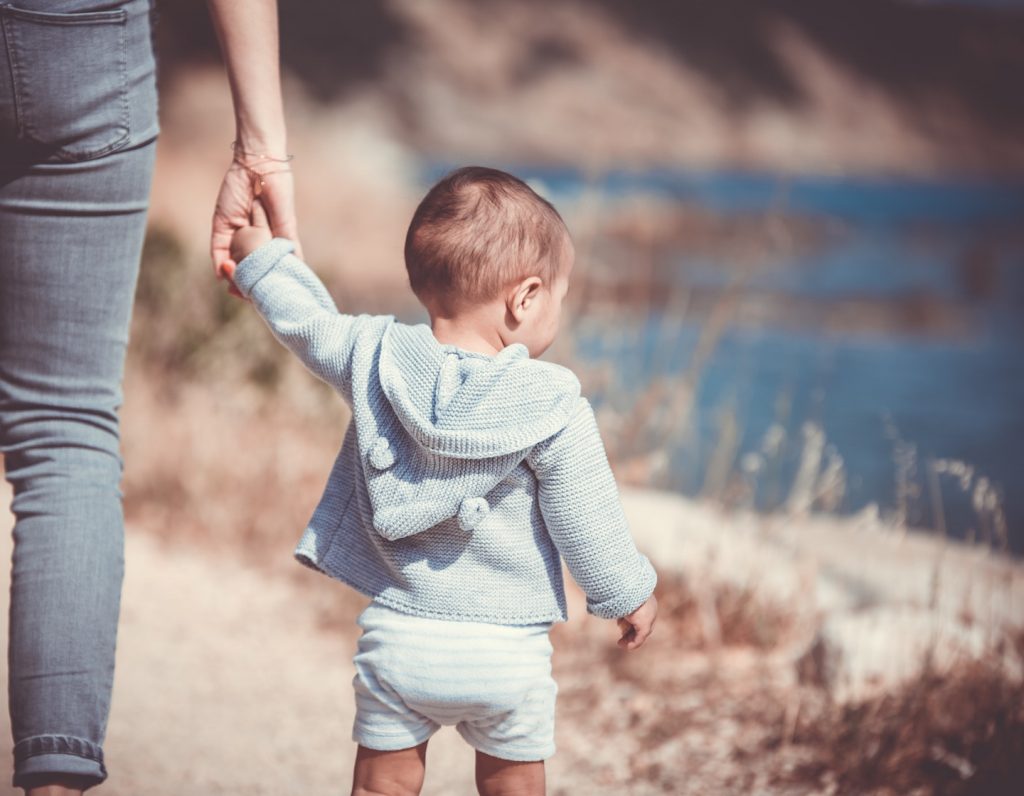 Mum holding toddler hand potty training