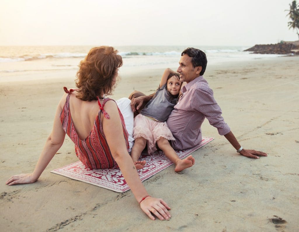 Family on beach arguing in front of kids