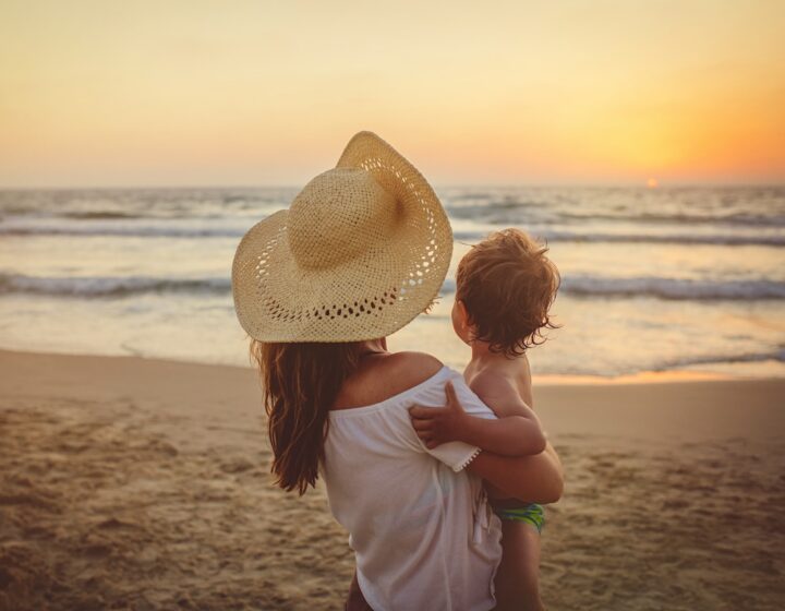 mother and newborn baby on a beach