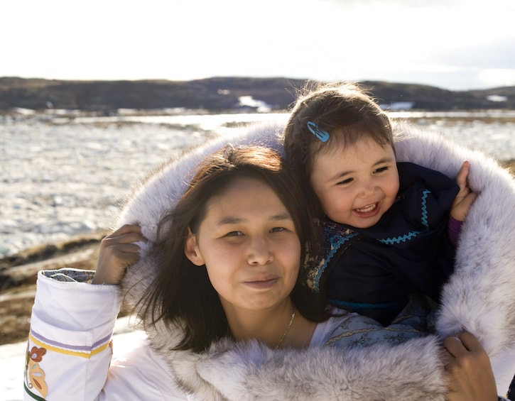 Inuit mother and her daughter wrapped up warm, child emotions Inuits