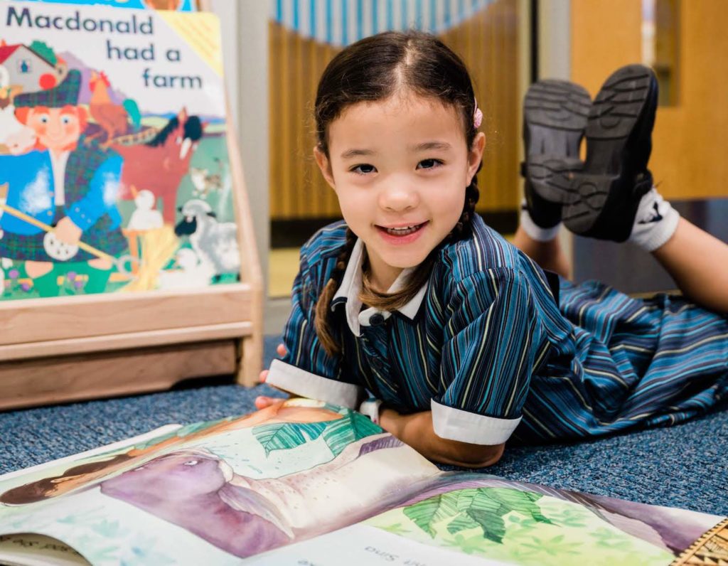 Child reading a book at the Australian International School Singapore