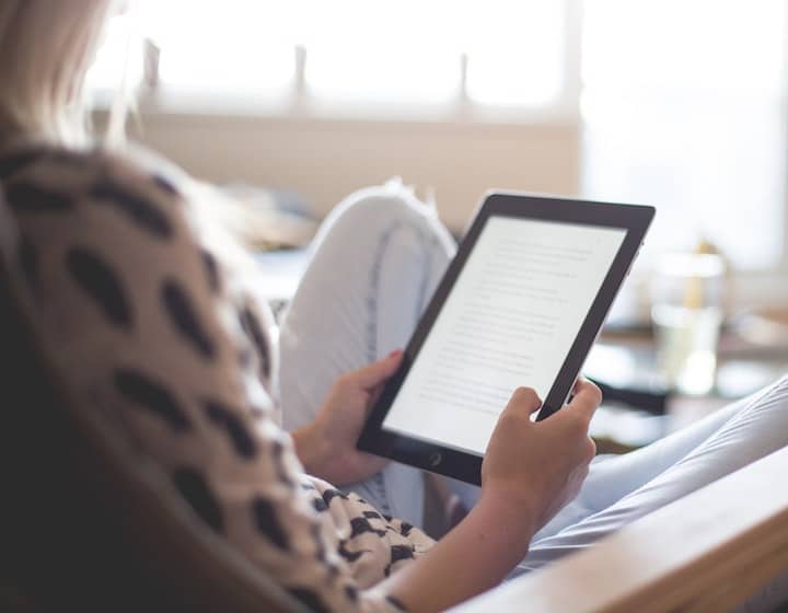 Mum reading a parenting book on a tablet