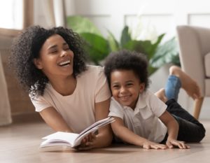 Mum and child reading a parenting book together