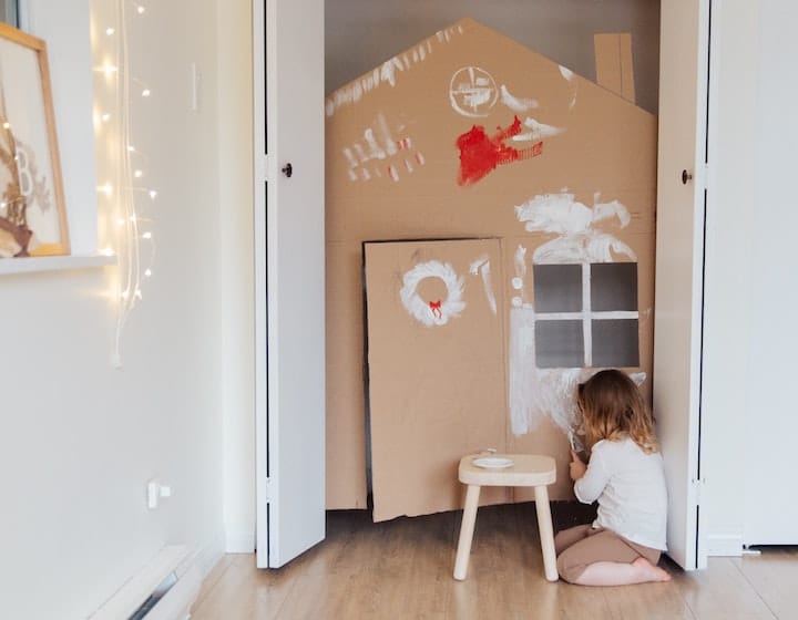 Young girl using her imagination to make a playhouse