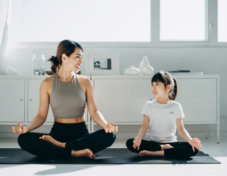 Family wellness goals for 2021, mama and children meditate on the sofa