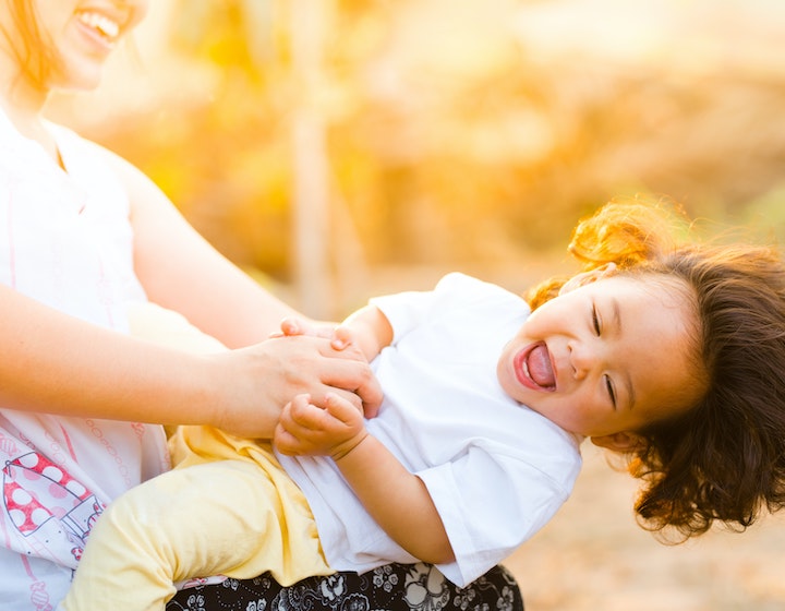 Mama and child playing and laughing