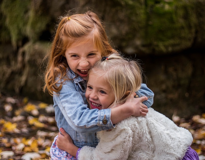 young kids saying goodbyes