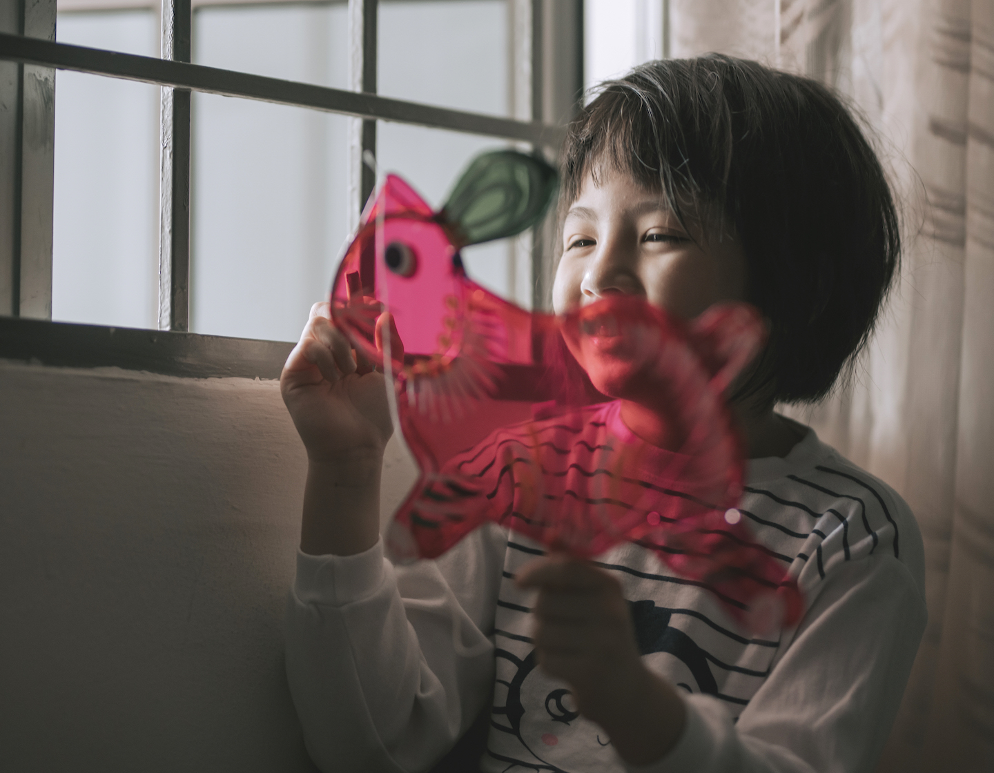 asian chinese young girl drawing on the rabbit shape chinese lantern preparing for mid autumn festival at night