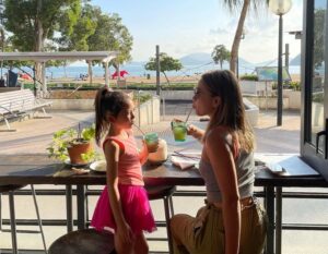 mother and daughter enjoying a drink at Limewood restaurant overlooking repulse bay beach