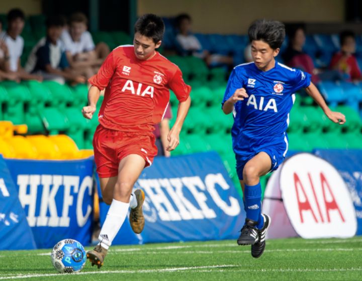 hong kong football club, two kids playing football during football class Football Classes For Kids, tweens and teens