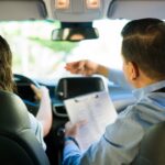a Hong Kong driving instructor teaches a student to drive at a Hong Kong driving school