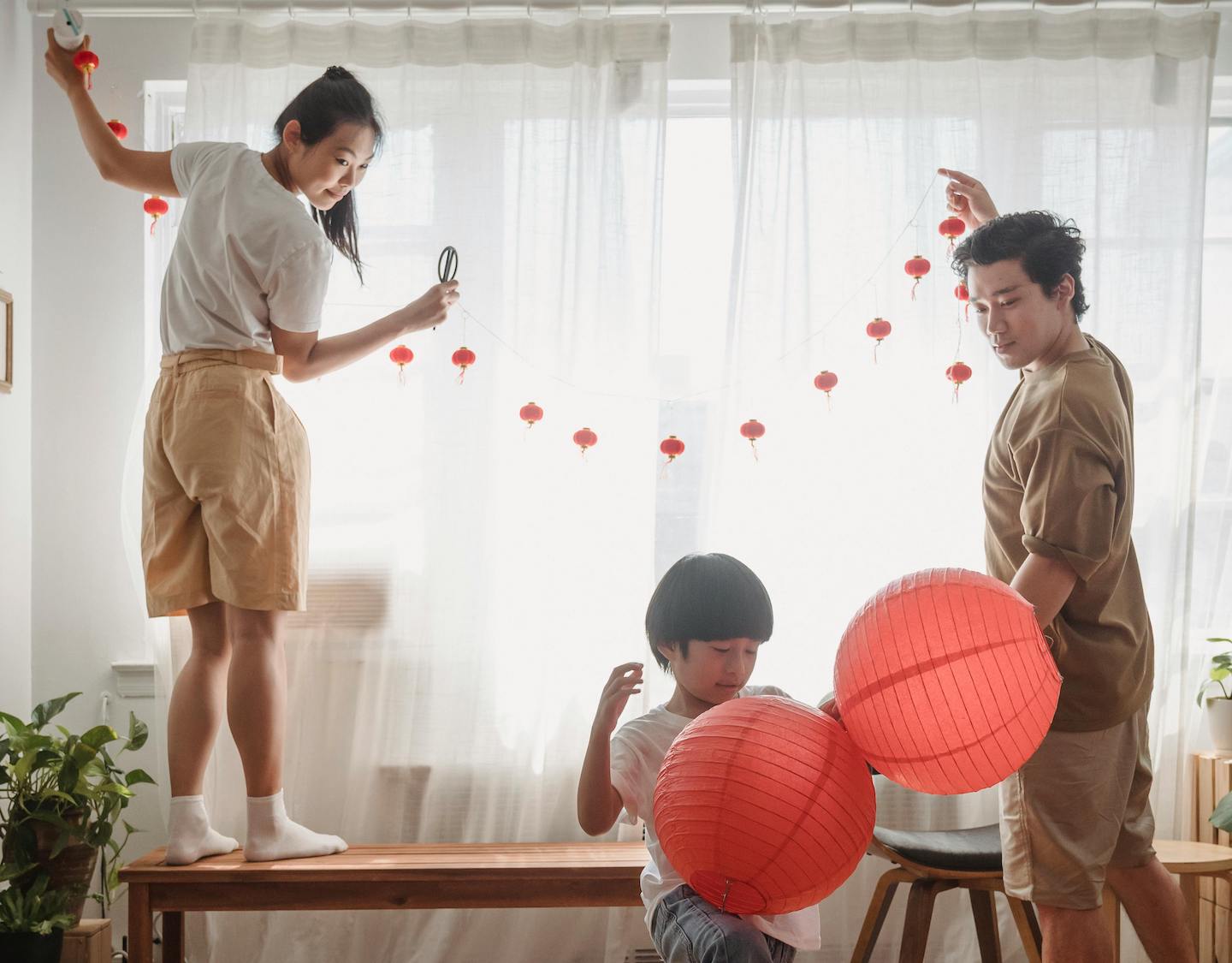 a family celebrates mid-autumn festival at home in Hong Kong by decorating their apartment