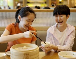 kids enjoying yum cha dishes at dim sum in Hong Kong