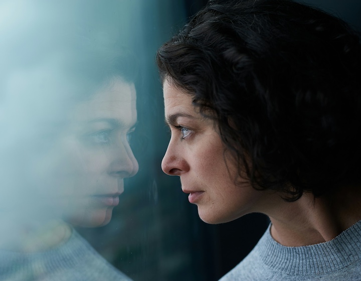 everything you need to know about perimenopause, women's health, woman looking at her reflection
