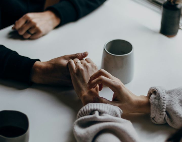 couple cafe holding hands coffee date