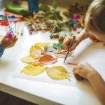 Children doing autumn handcrafts at a school holiday class