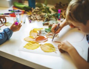 Children doing autumn handcrafts at a school holiday class