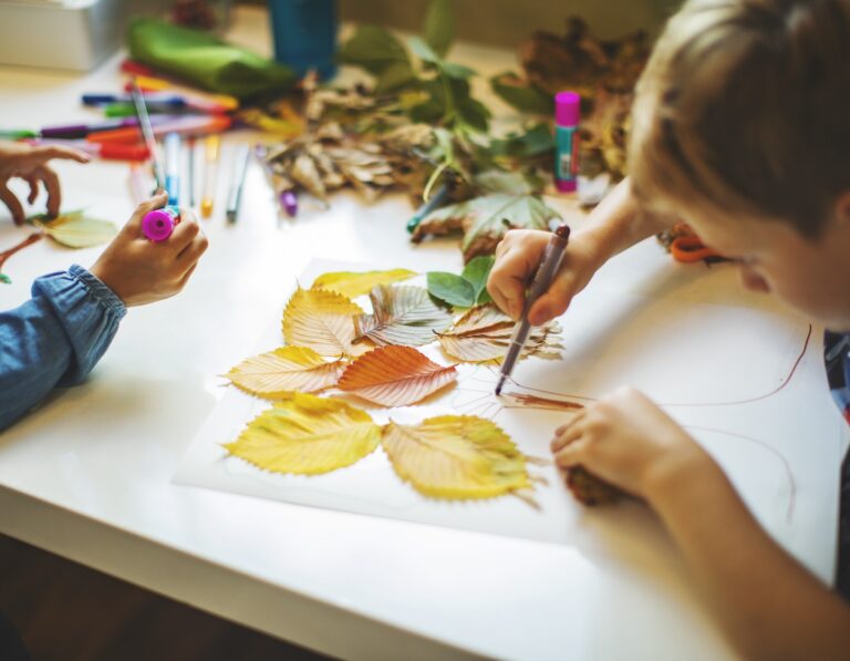 Children doing autumn handcrafts at a school holiday class