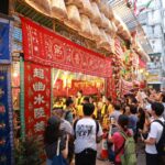 a crowd gathers outside a yu lan offering and celebration for the hungry ghost festival in Hong Kong