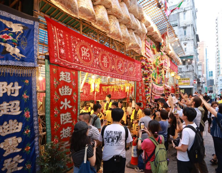 a crowd gathers outside a yu lan offering and celebration for the hungry ghost festival in Hong Kong