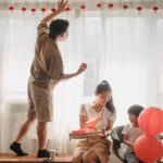 family putting up red lanterns to celebrate mid-autumn festival 2026 in Hong Kong