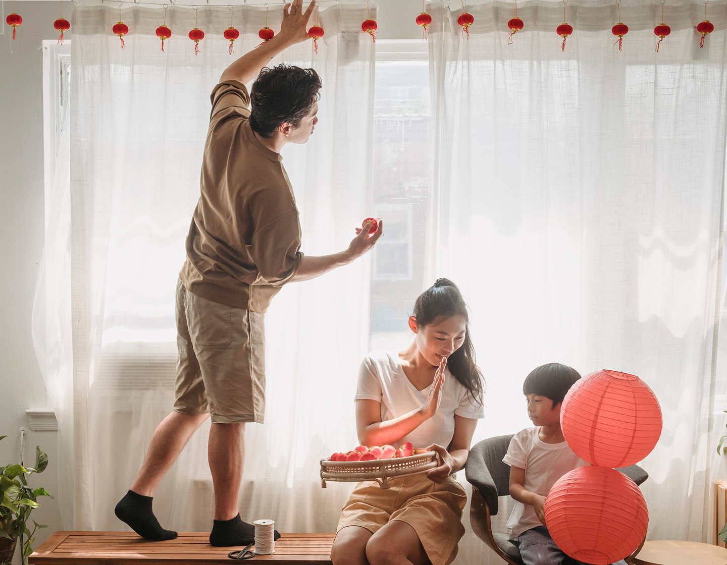 family putting up red lanterns to celebrate mid-autumn festival 2026 in Hong Kong