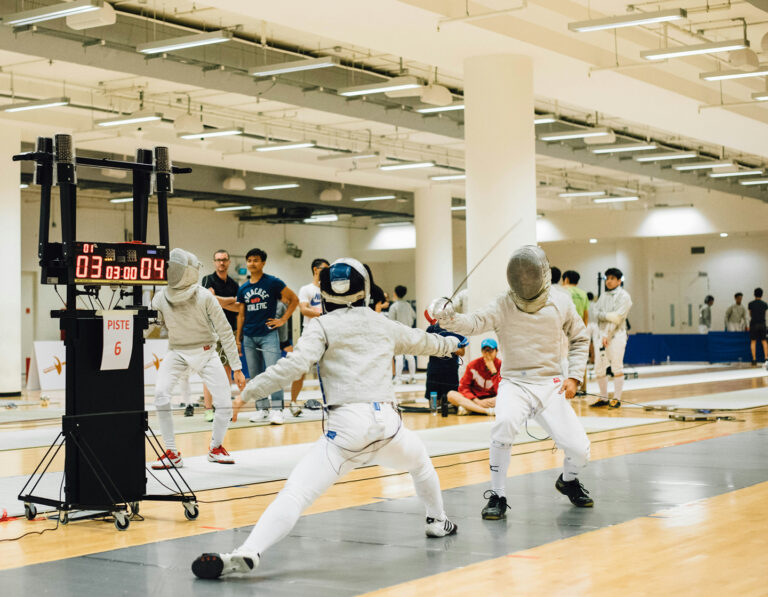 hong kong fencing schools for kids, two fencing students in a tournament in HK