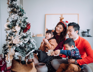 Asian family decorating Christmas tree in HK
