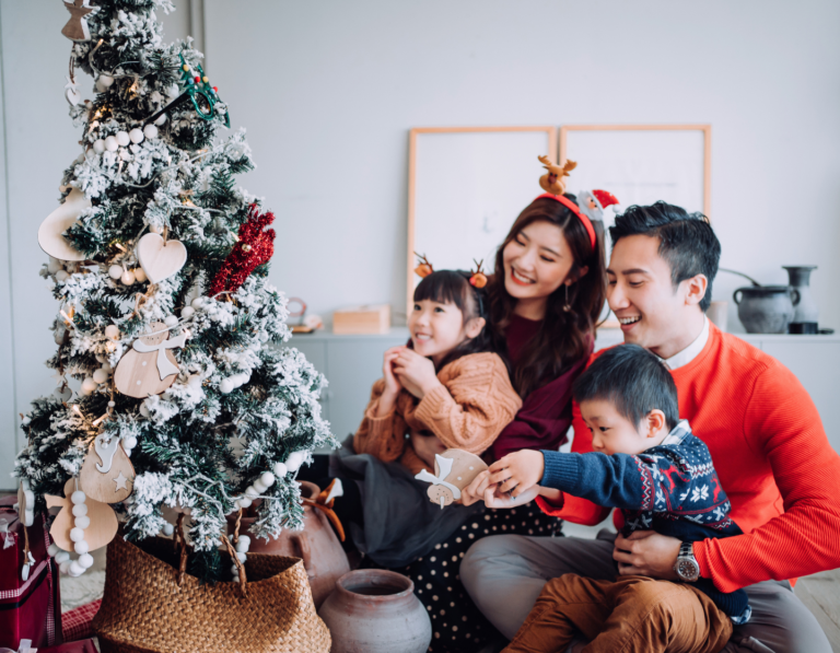 Asian family decorating Christmas tree in HK