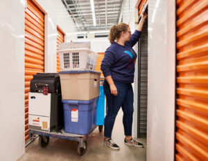 best storage companies in hong kong, woman adding items to her storage unit