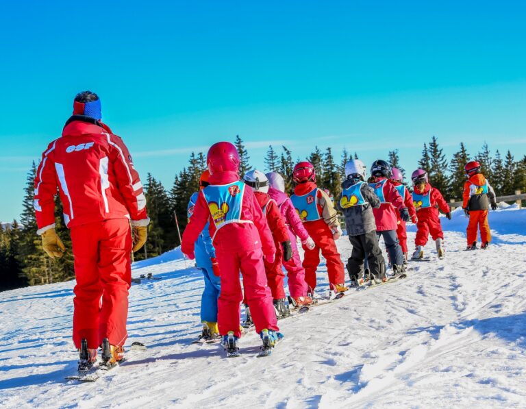 a group of ski students with an instructor at an international camp