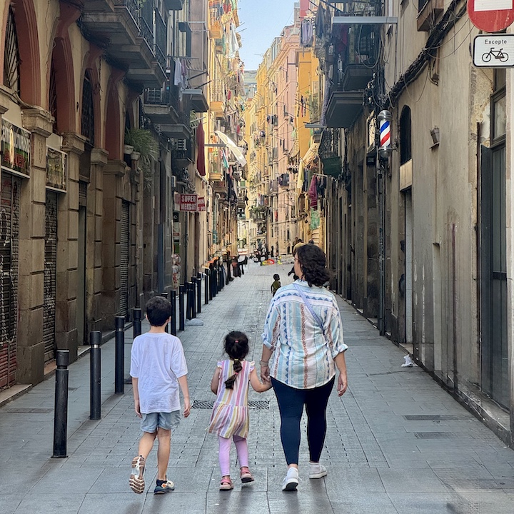 mother and children walk through Barcelona in summer
