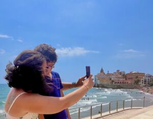 European summer holiday mother and son selfie Spain beach