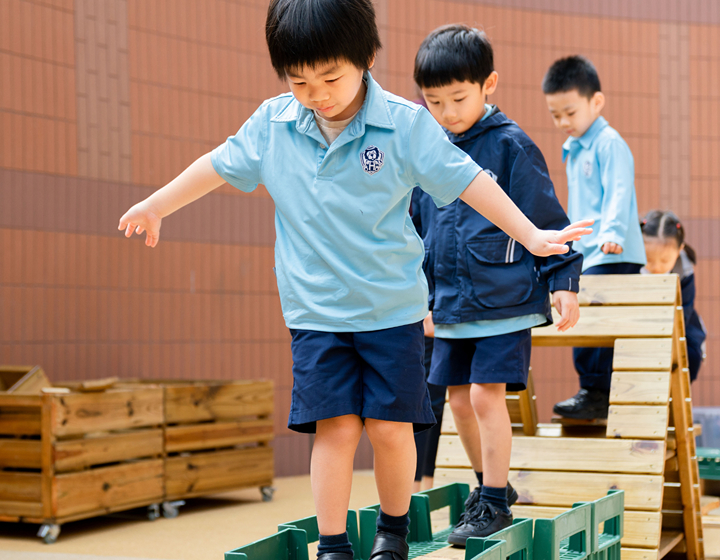 Harrow Little Lions Kindergartens, preschool students climbing on blocks