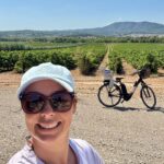 selfie of woman with bike in vineyards