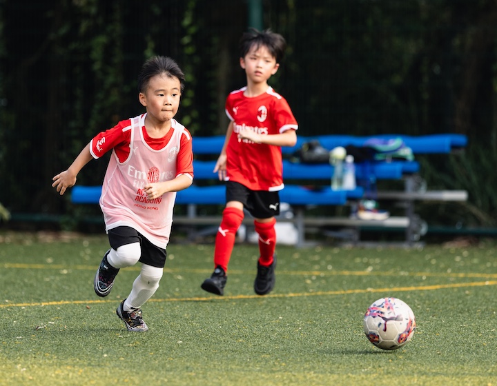 two boys play football at an ac Milan workshop in Hong Kong for the fifa World Cup