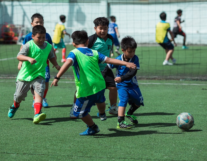 children play football in Hong Kong