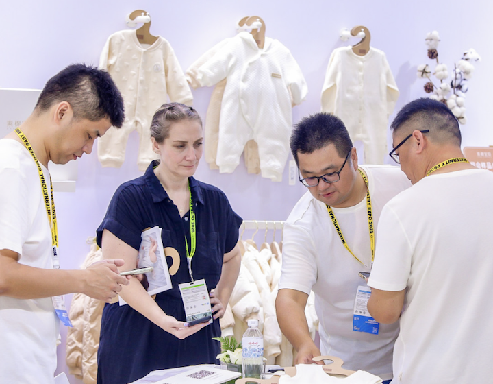 woman discusses sourcing baby clothes at CMBE Shanghai