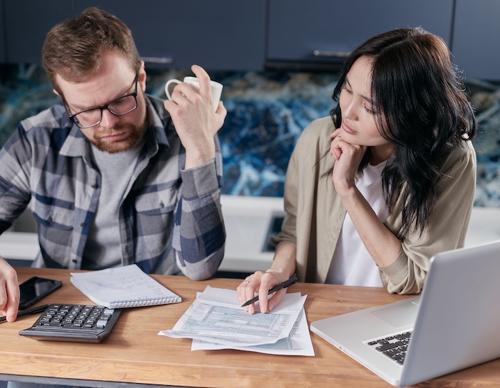 a man and woman discuss their family finances before consulting a Hong Kong financial advisor