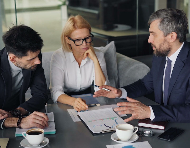 a financial advisor in Hong Kong meets with an expat couple