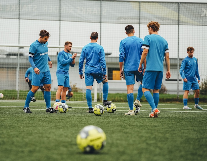 mens football team wearing light blue jerseys
